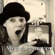 Malone sings to Fauci, with the words displayed: My god, are you top notch.