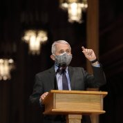 Fauci gestures from lectern.