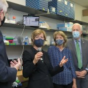 One senator holds a microphone and poses a question to Collins