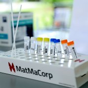 The mini-lab features several test tubes and two nasal swabs