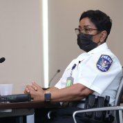 Black female in police uniform and facemask