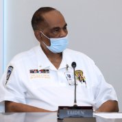 Black male in uniform and facemask
