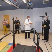 Four individuals stand in specially designed gym-like room