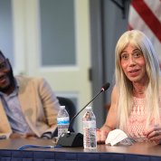 Seated at long table, McCullough and Boyle serve on a panel 
