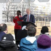 Van Hollen speaks from the podium, with sign language interpreter beside him.