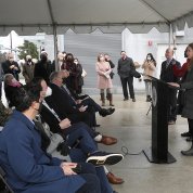 Schwetz at podium with seated crowd in front of her.