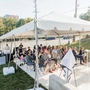 Farias speaks at event held under a tent 