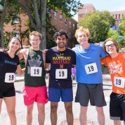 Five runners smile into camera.