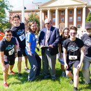 In front of Bldg. 1, McGowan and Tabak strike poses amid team runners.