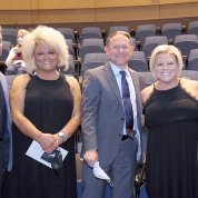 Several people smile into camera