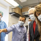 Sessions and a a group look at where Bharti points off screen