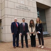 Sessions and leadership stand in front of the Clinical Center