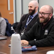 DEM staff sit at a conference table