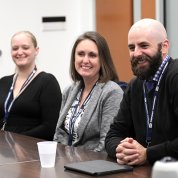 Three staff sit at a conference table