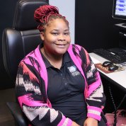 Neal smiles in her chair. 