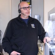 Mowbray wears a headset in the center