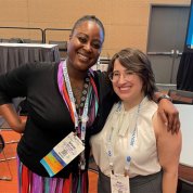 A smiling Holloway poses with a workshop participant.