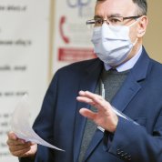 Zarate, with notes in one hand and the other extended face down, discusses mental health research.