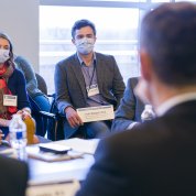Two NIH fellows sit, masked, introducing themselves.