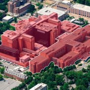 A screenshot shows a close-up aerial view of the Clinical Center complex, surrounded by other buildings