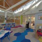 Toys, books and tables and chairs in the large and bright playroom inside the Children's Inn