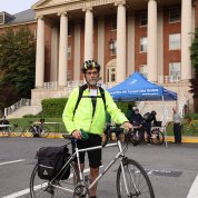 NIMH’s Jerry McGuire poses with bike in front of Bldg. 1