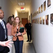 Johnson, Schwetz and McGowan look at photos on the wall of fires and other emergencies.
