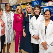 Smiling group poses for photo in an NCI lab.