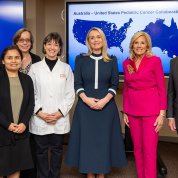 NCI members, Bertagnolli, Haydon and Biden pose in front of Cancer Moonshot slide