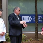 In outdoor courtyard, Bertagnolli, Tabak and Biden chat informally