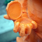 A hand of a statue holding a petri dish