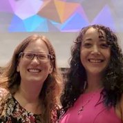 Two women smile into camera