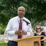 Johnson speaks into mic at podium