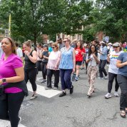 Large group of walkers setting out on street near Bldg. 1