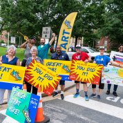 Group of people hold big, bright signs: you did it! Great job! Finish!