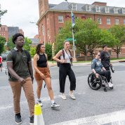 Group of people standing and one person in a wheelchair outside Bldg. 1