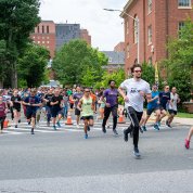 Group of runners takes off in the street.
