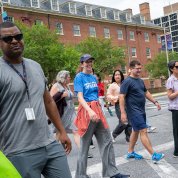 Smiling walkers on street near crosswalk