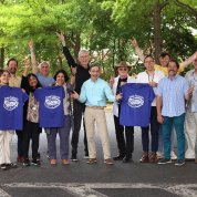 The ARRA band poses in front of a tree, holding purple Camp Fantastic BBQ t-shirts.