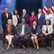 large group photo with U.S. and PHS flags behind them on either side