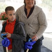 Angel and his mother hold shovels