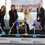 The ceremony's speakers hold shovels and break ground 