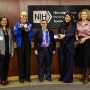 Rubins and some of her co-panelists, holding small plaques.