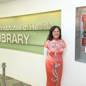 Wong stands next to the exhibit