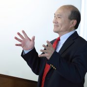 Liang speaks at the podium