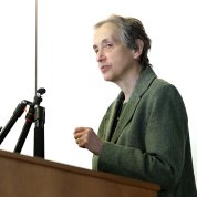 Schor speaks at the podium