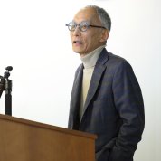 Hashimoto speaks at a podium