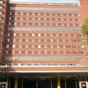 The exterior of the E wing, a multistory brick building with many windows