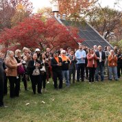 A group of onlookers watch during the outdoor ceremony