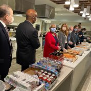 The line of masked servers stand at the ready.